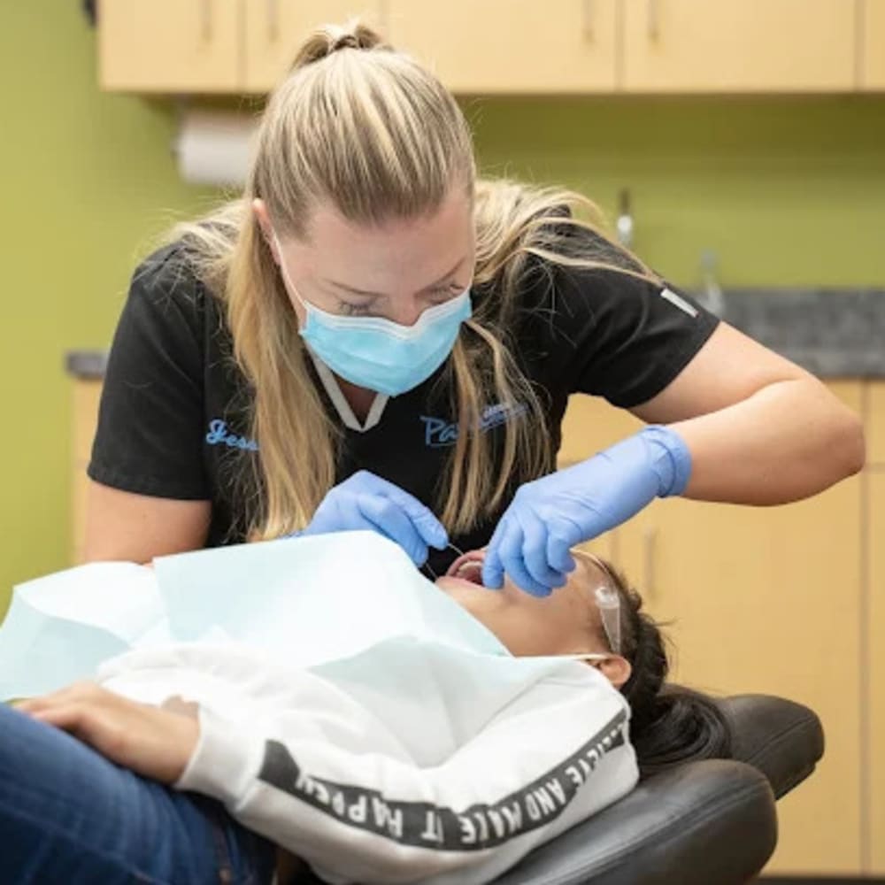 A team member at Pavlo Orthodontics works on a patient.